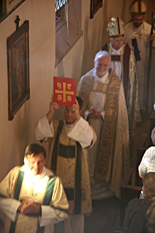 The Deacon carries the Gospel Book in the procession