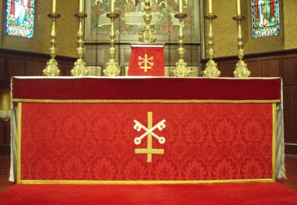 Red altar frontal with St Peter's emblem