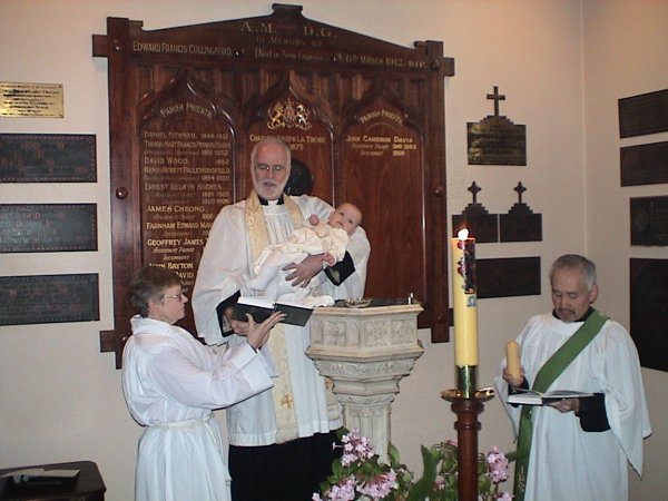 Fr John Davis at a Baptism